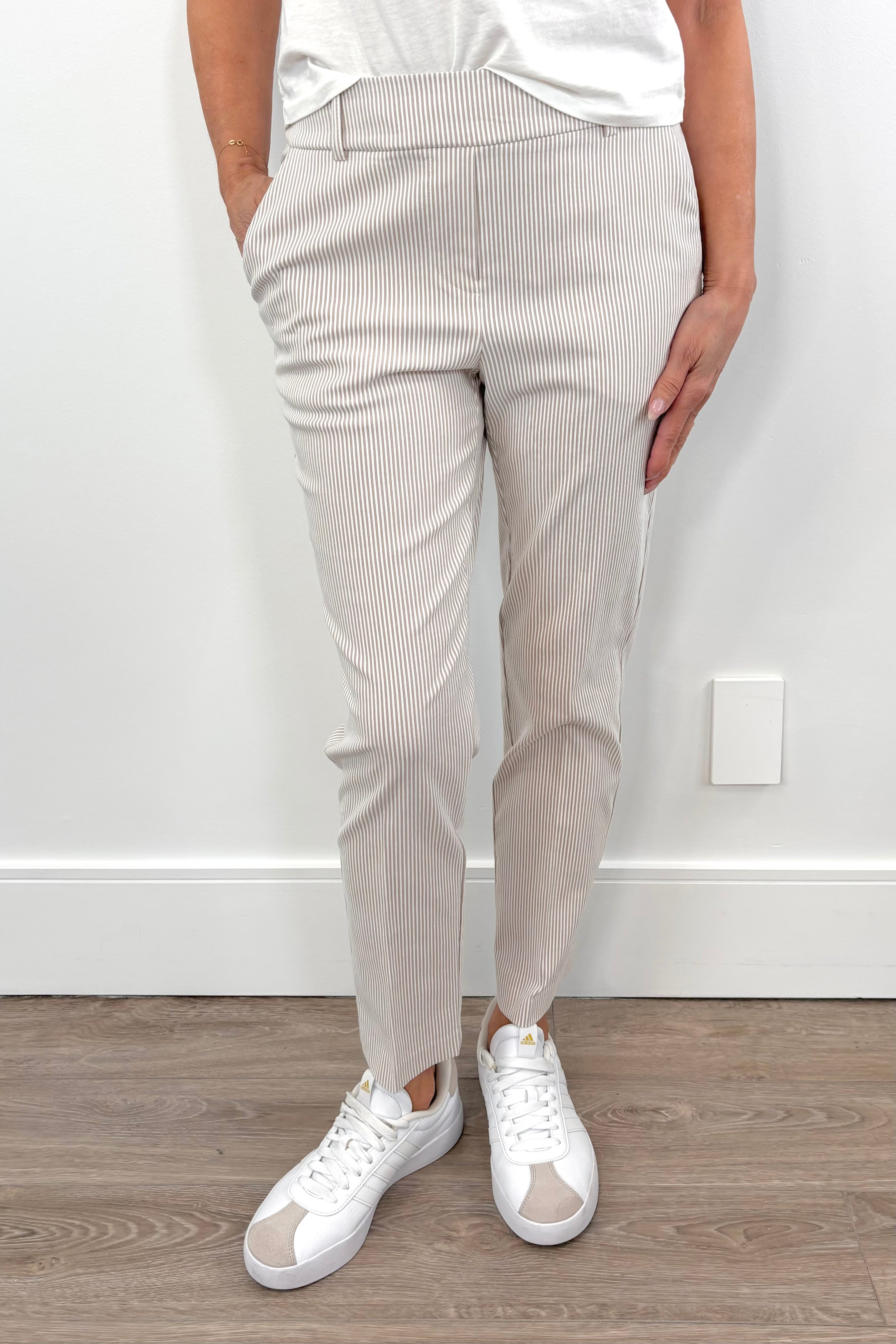 woman wearing an ankle length beige stripped pants