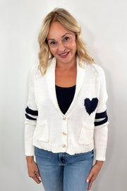 Woman wearing white cardigan with navy detail