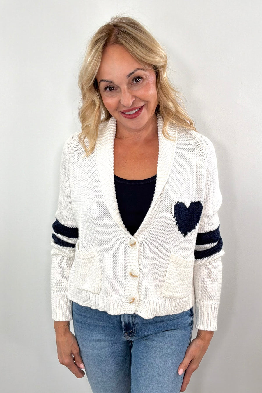 Woman wearing white cardigan with navy detail