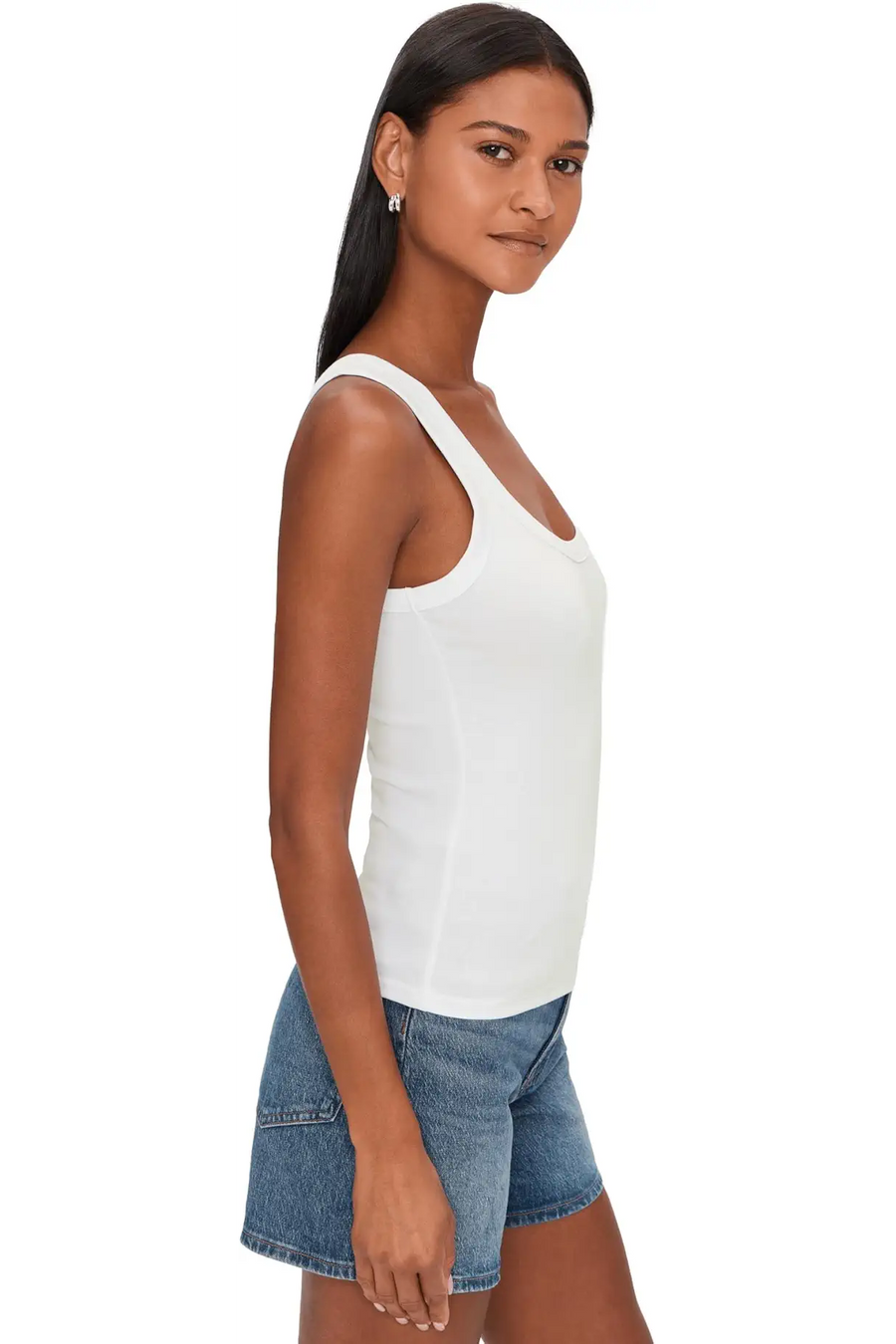 Woman wearing a white ribbed tank top with scoop neckline