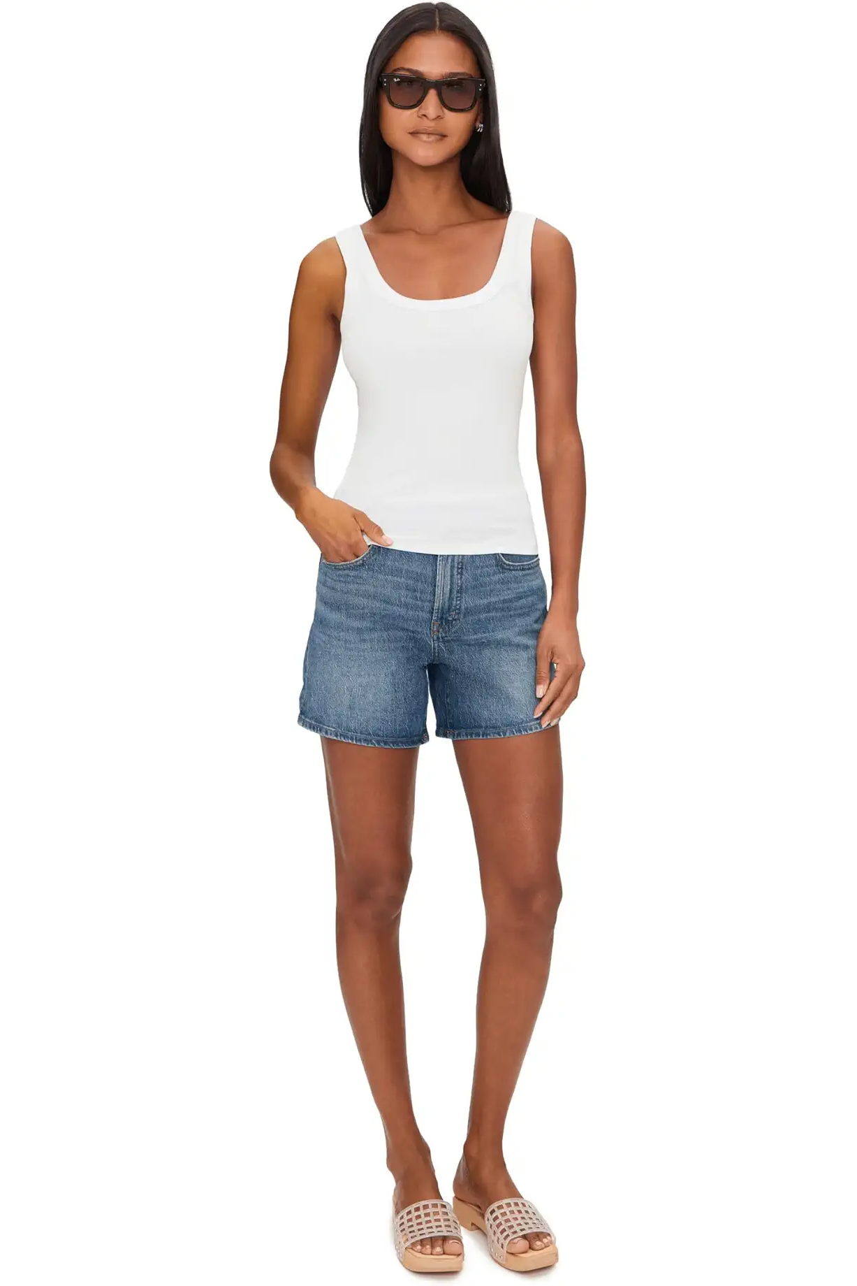 Woman wearing a white ribbed tank top with scoop neckline