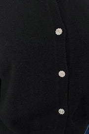 Close-up of the crystal buttons of a black cardigan