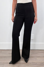 Person wearing black flared pants