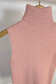 Close up of pink knitted turtleneck tank top