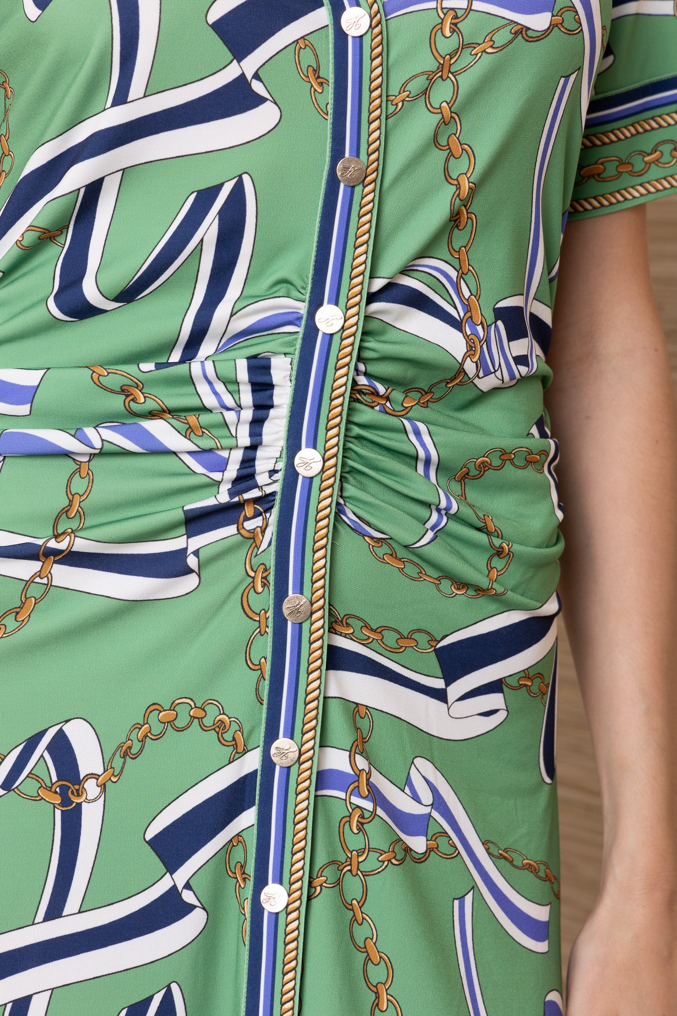 green maxi button up dress with blue and gold ribbon patterns