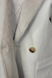 close-up of a faux leather reversible trench coat