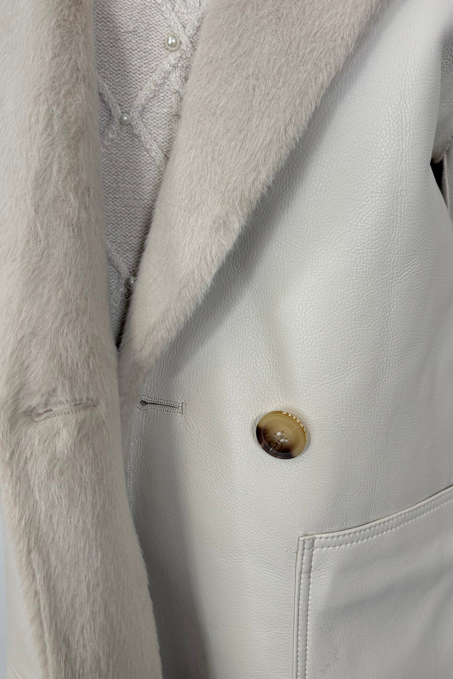 close-up of a faux leather reversible trench coat
