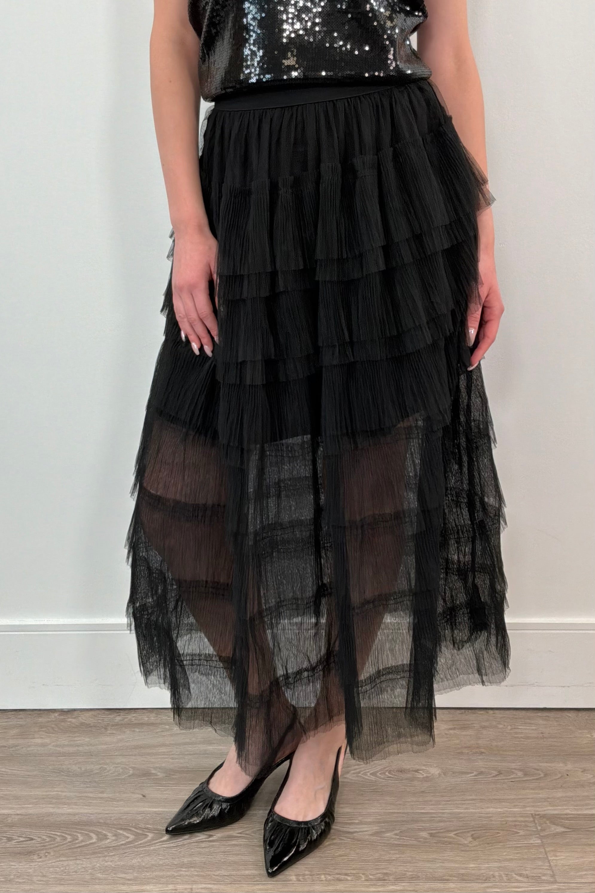 woman wearing a black tiered tulle midi skirt
