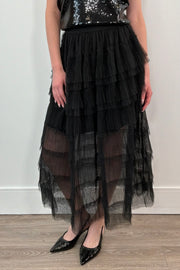 woman wearing a black tiered tulle midi skirt