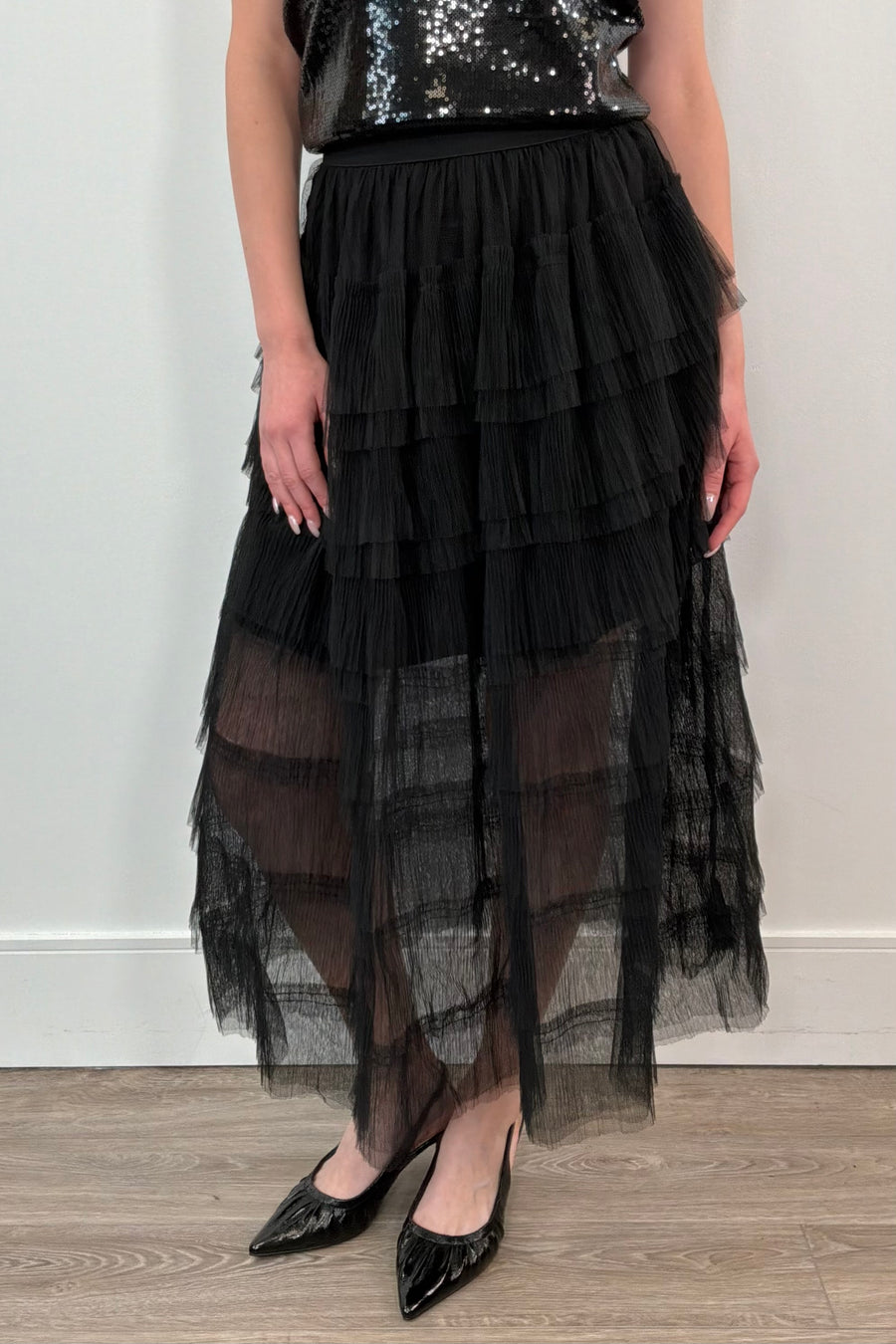 woman wearing a black tiered tulle midi skirt