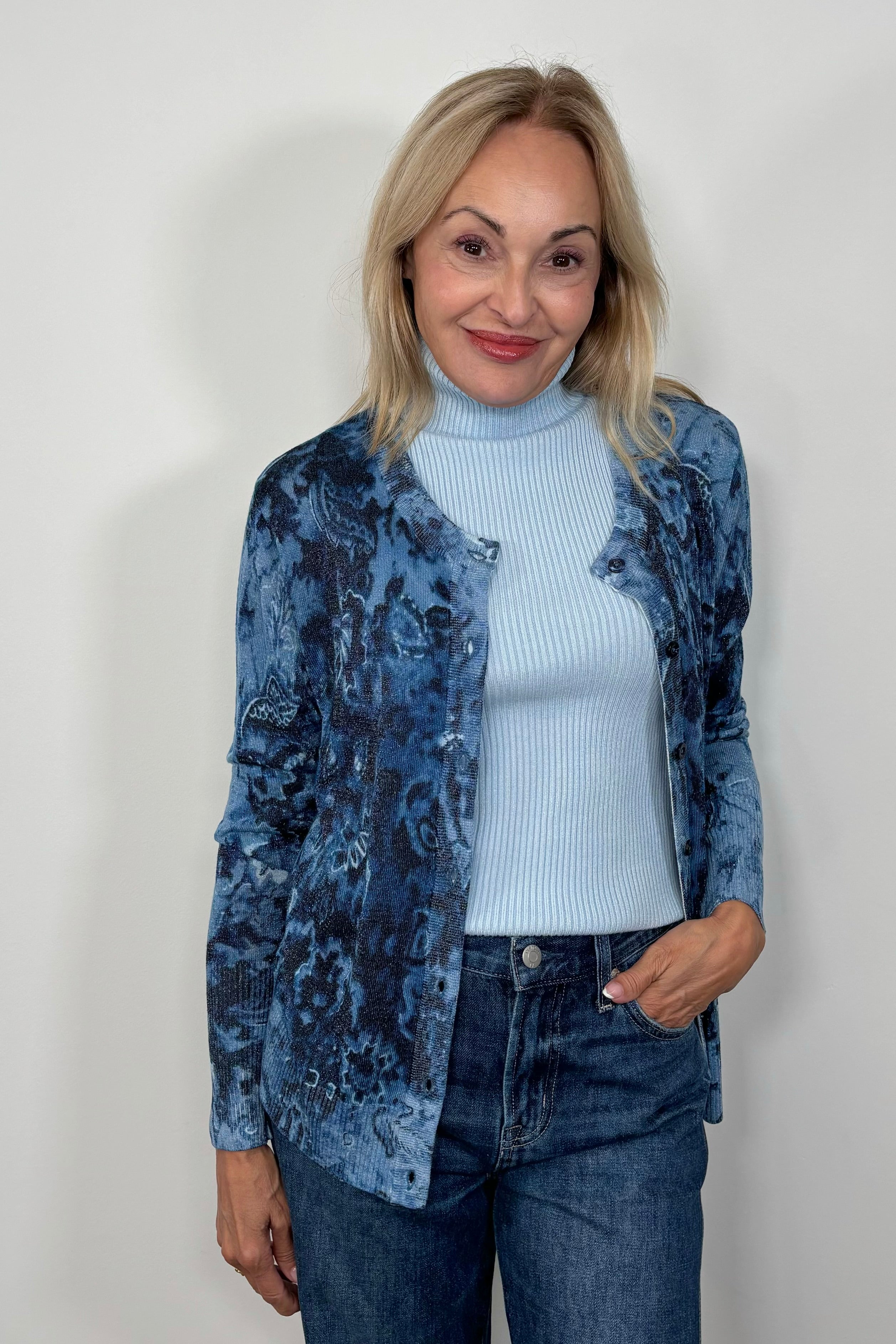 Front view of woman wearing a blue patterned thin cardigan open