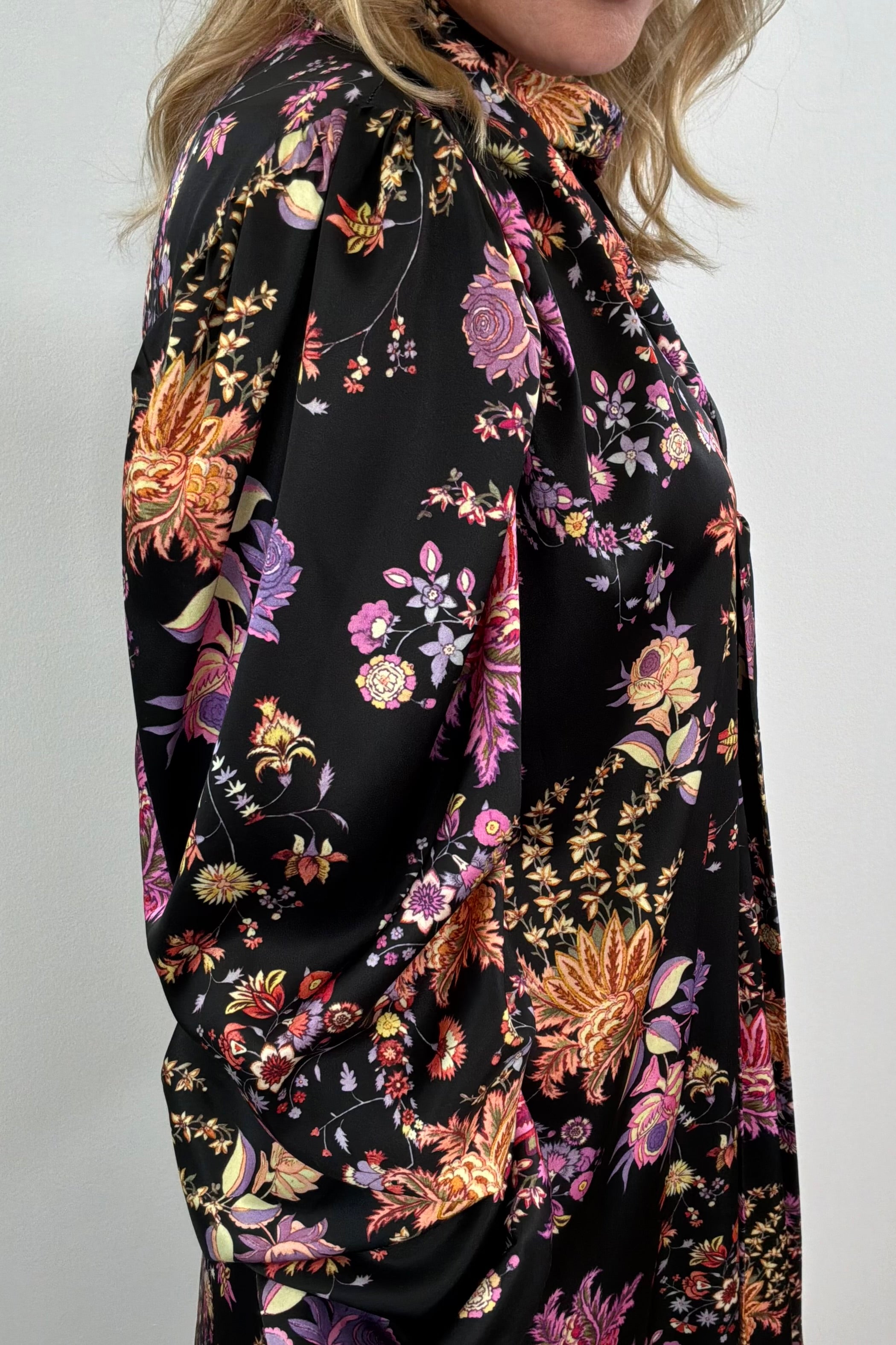 close-up of a woman wearing a black floral dress