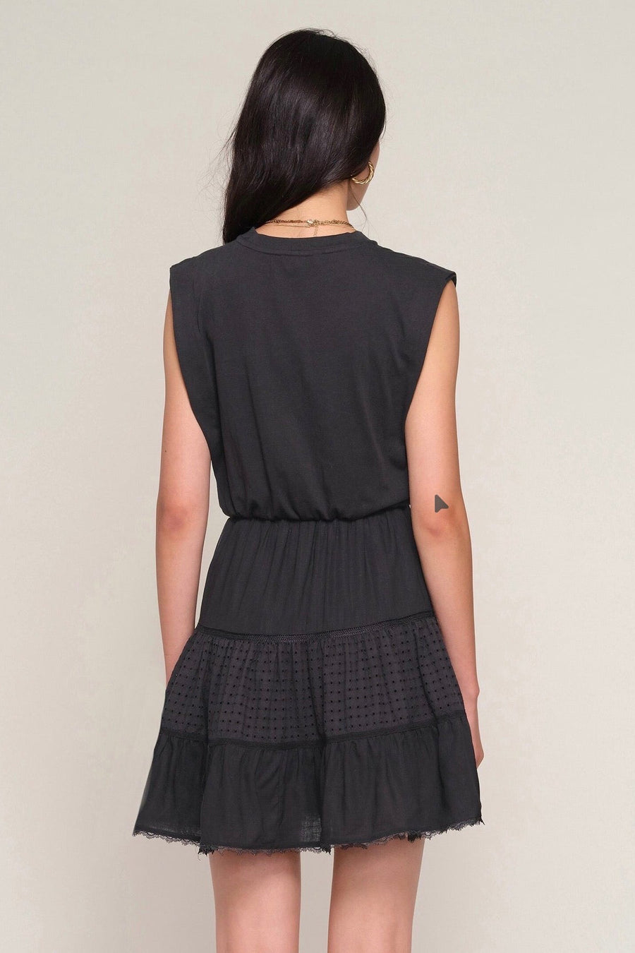 Back view of Woman wearing a black eyelet dress