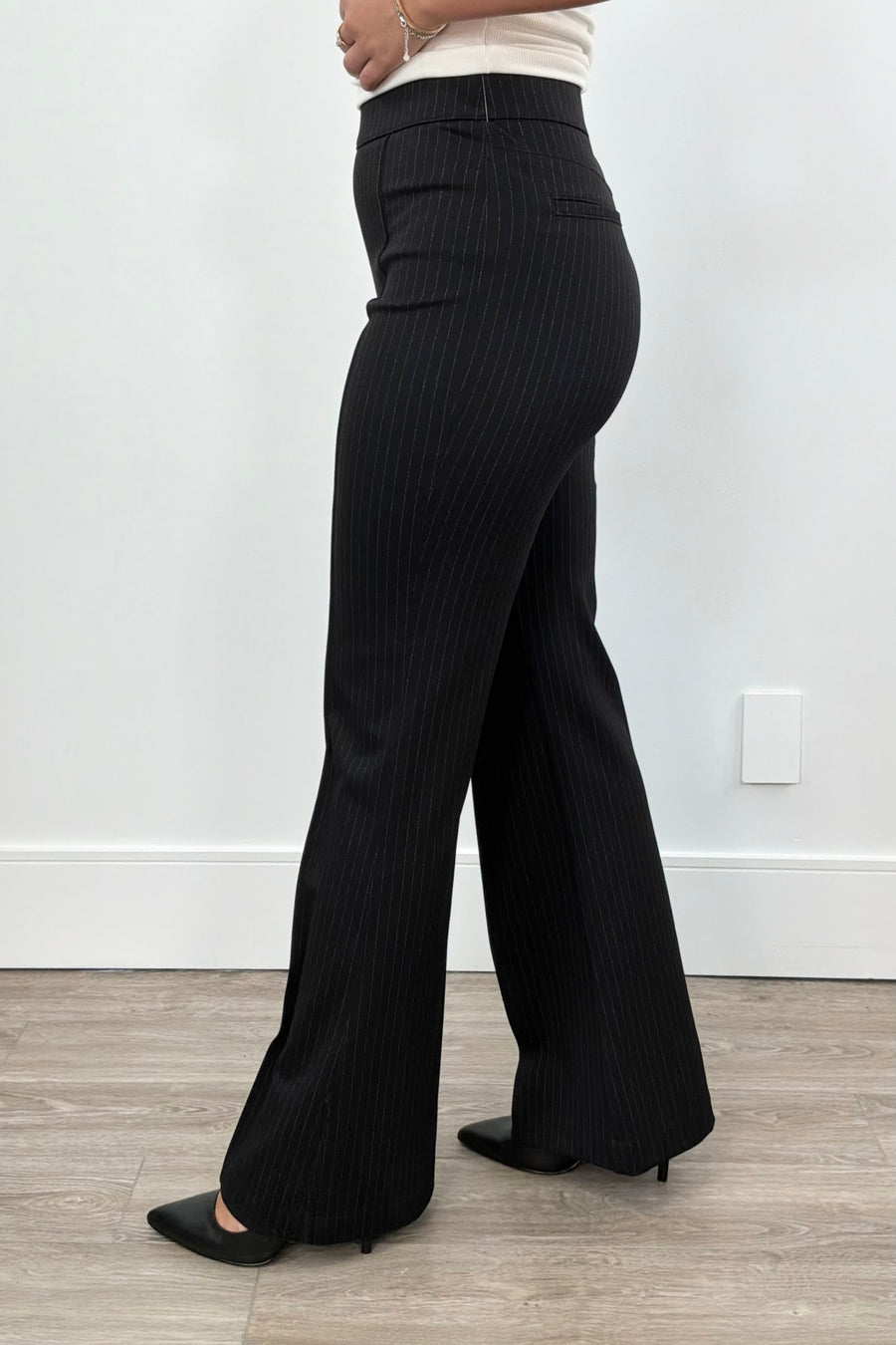 Person wearing black pinstripe pants