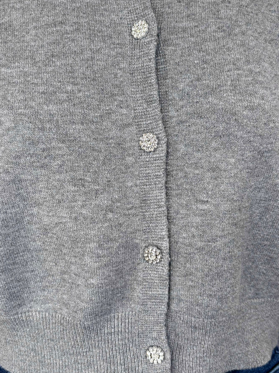 Close-up of a gray cardigan with crystal buttons
