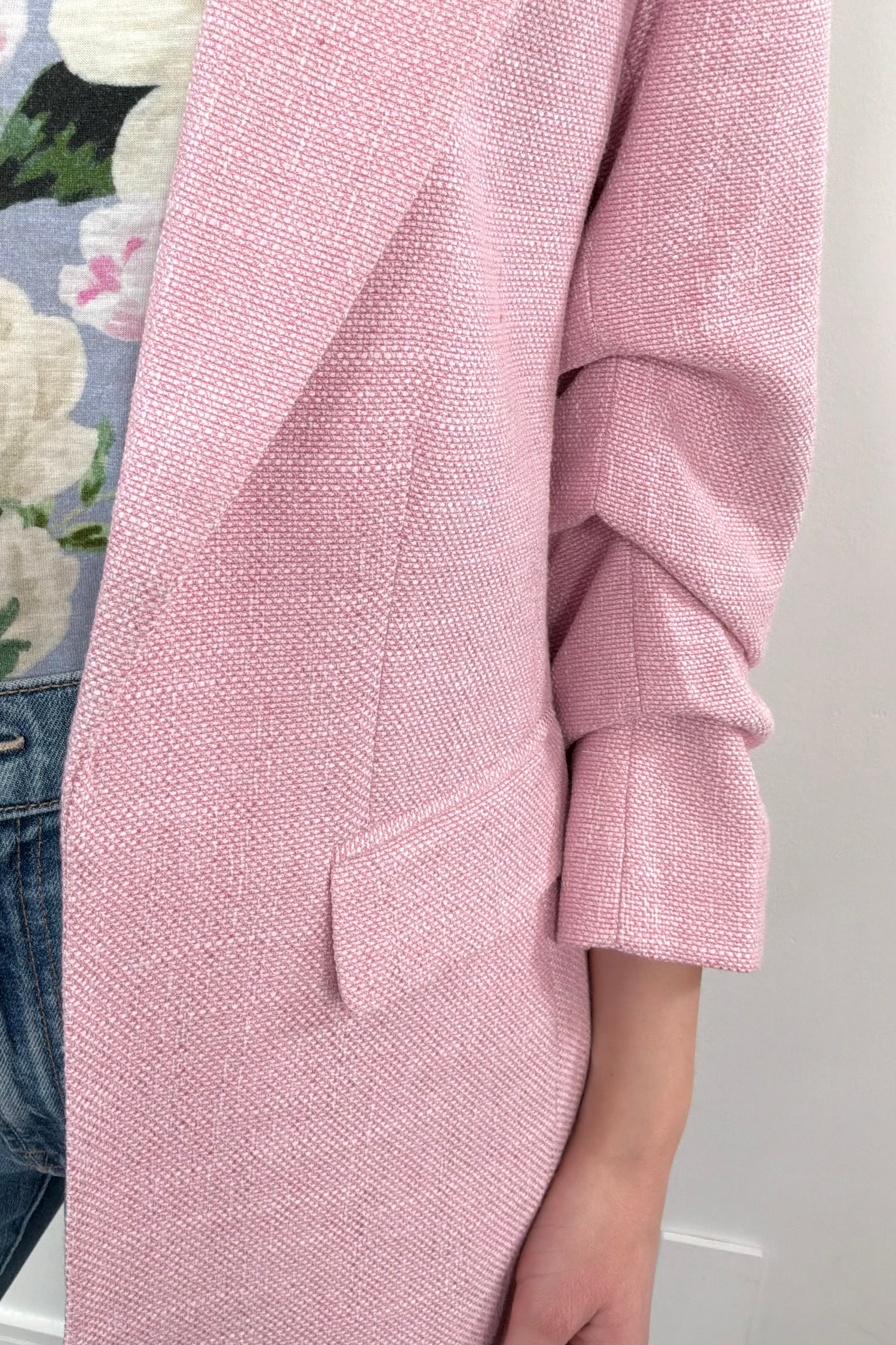 Close-up of the pocket of a pink open blazer