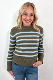 Woman wearing a green and blue striped sweater 