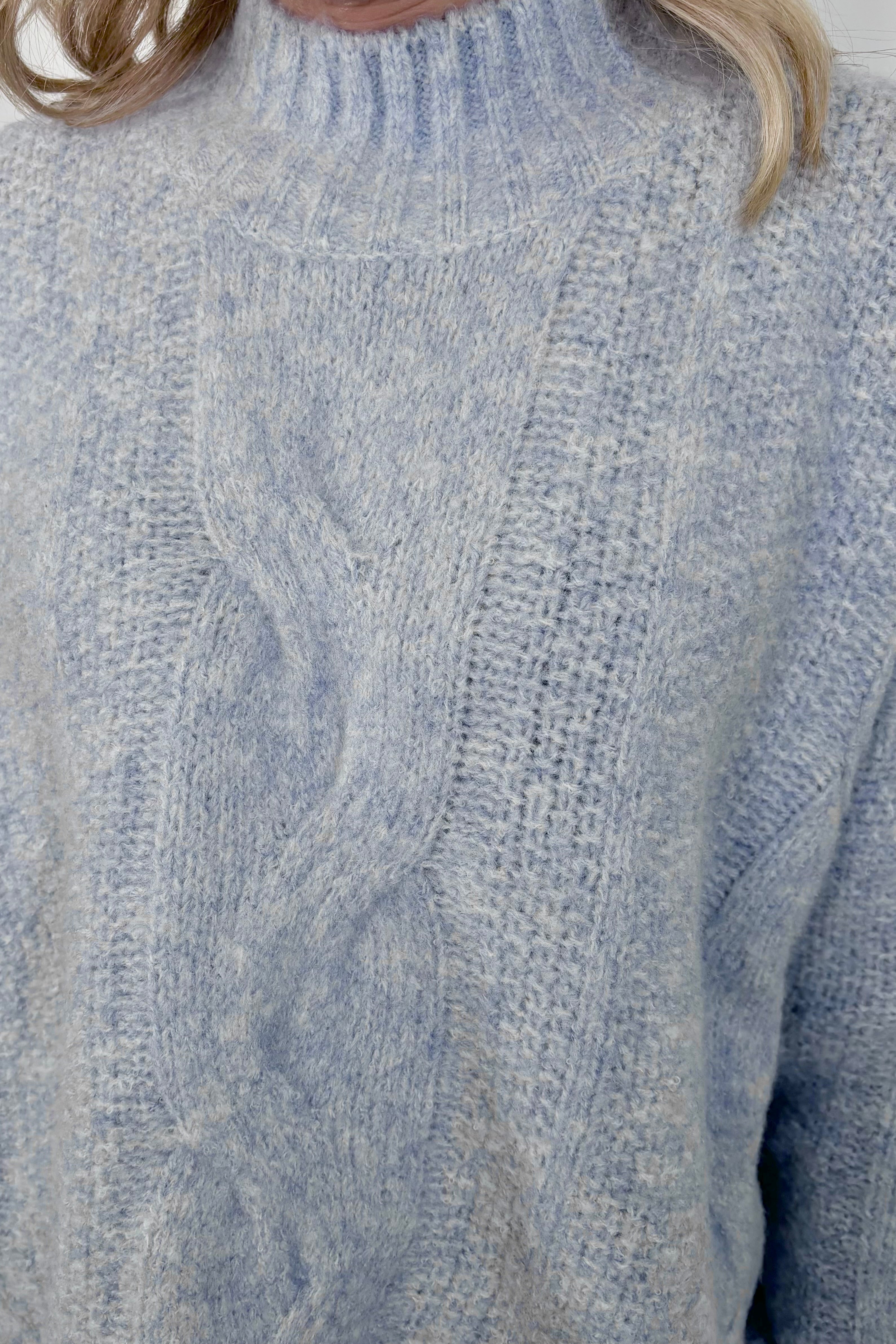 Close up of a high neck light blue knitted sweater 