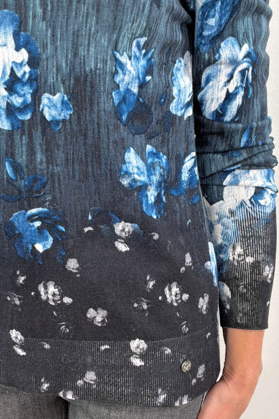 Close-up of a blue and black floral pullover sweater 