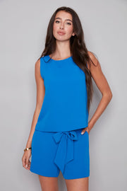 woman wearing blue vegan silk sleeveless top