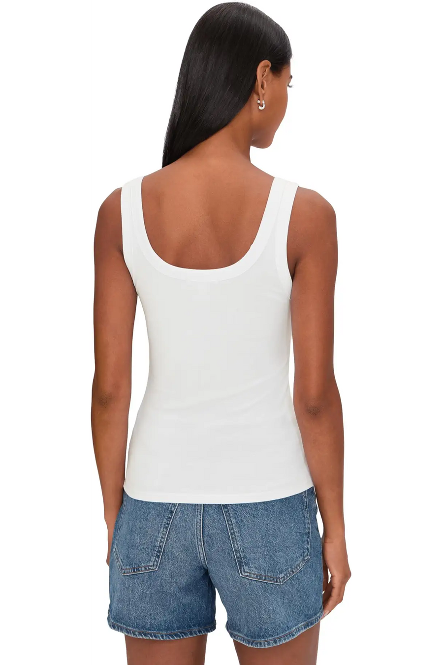 Woman wearing a white ribbed tank top with scoop neckline