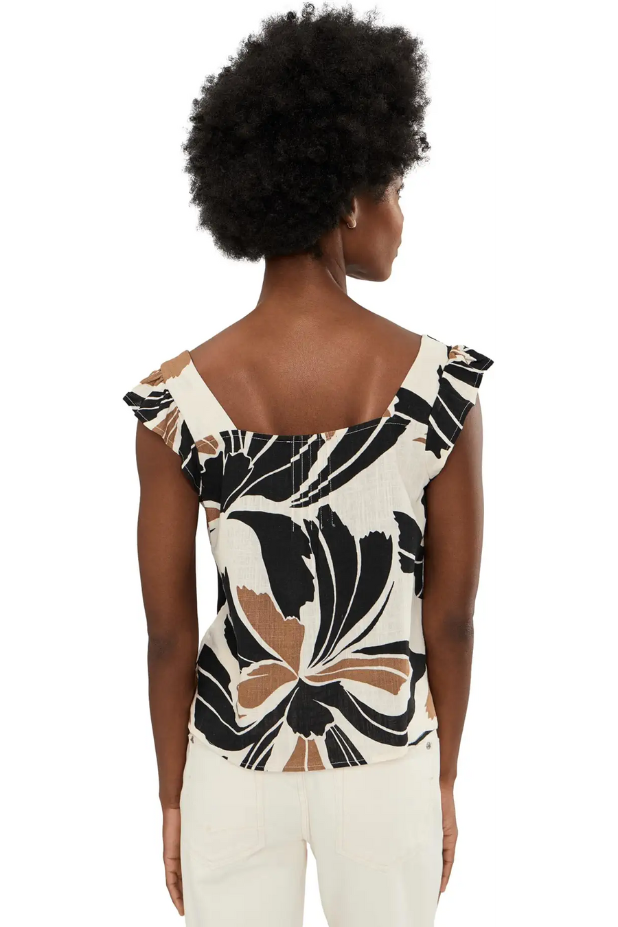 Woman wearing a sleeveless linen top with lotus pattern