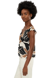 Woman wearing a sleeveless linen top with lotus pattern