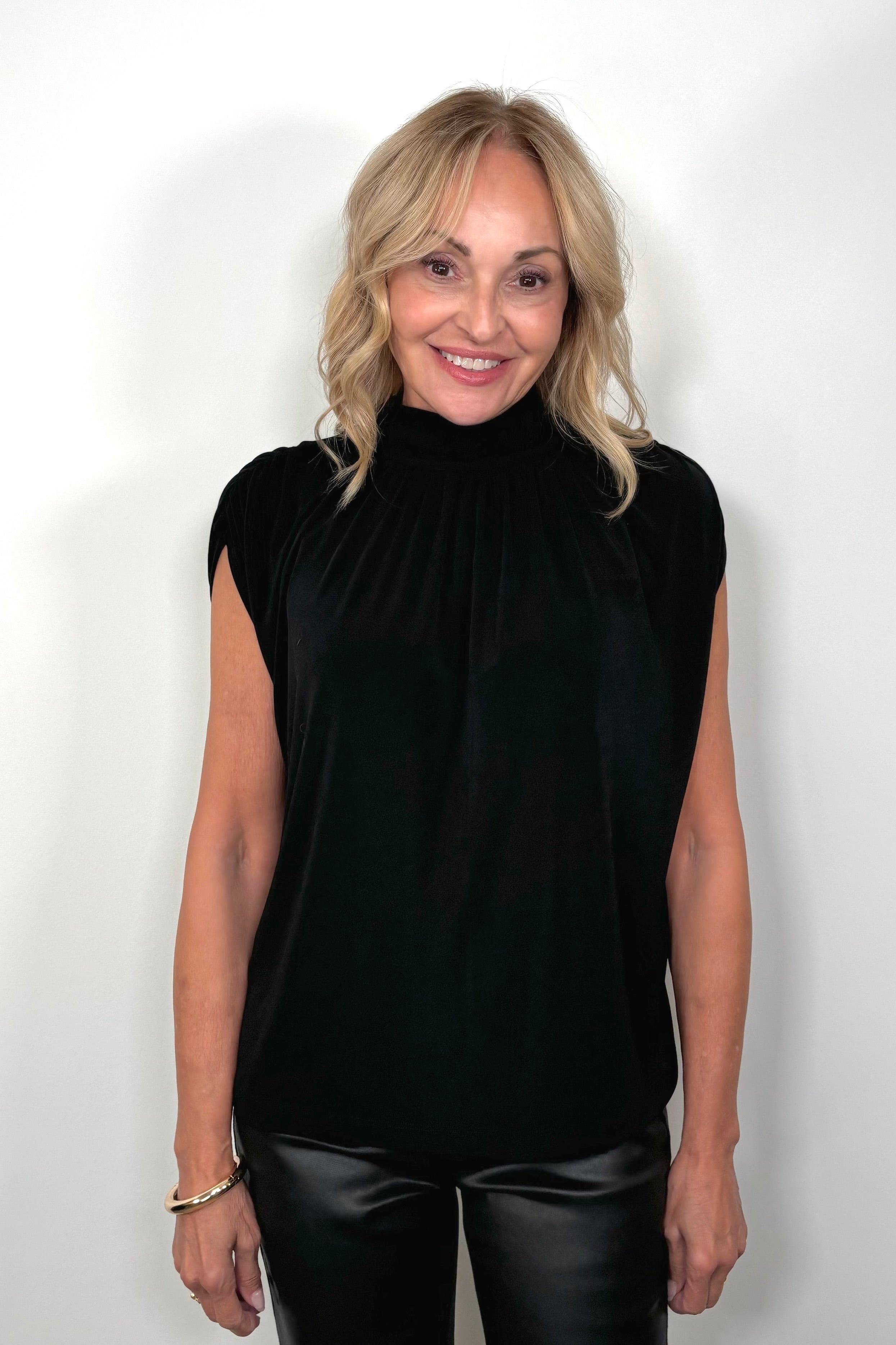 woman wearing a black mock neck top