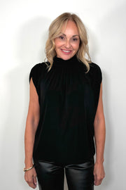 woman wearing a black mock neck top