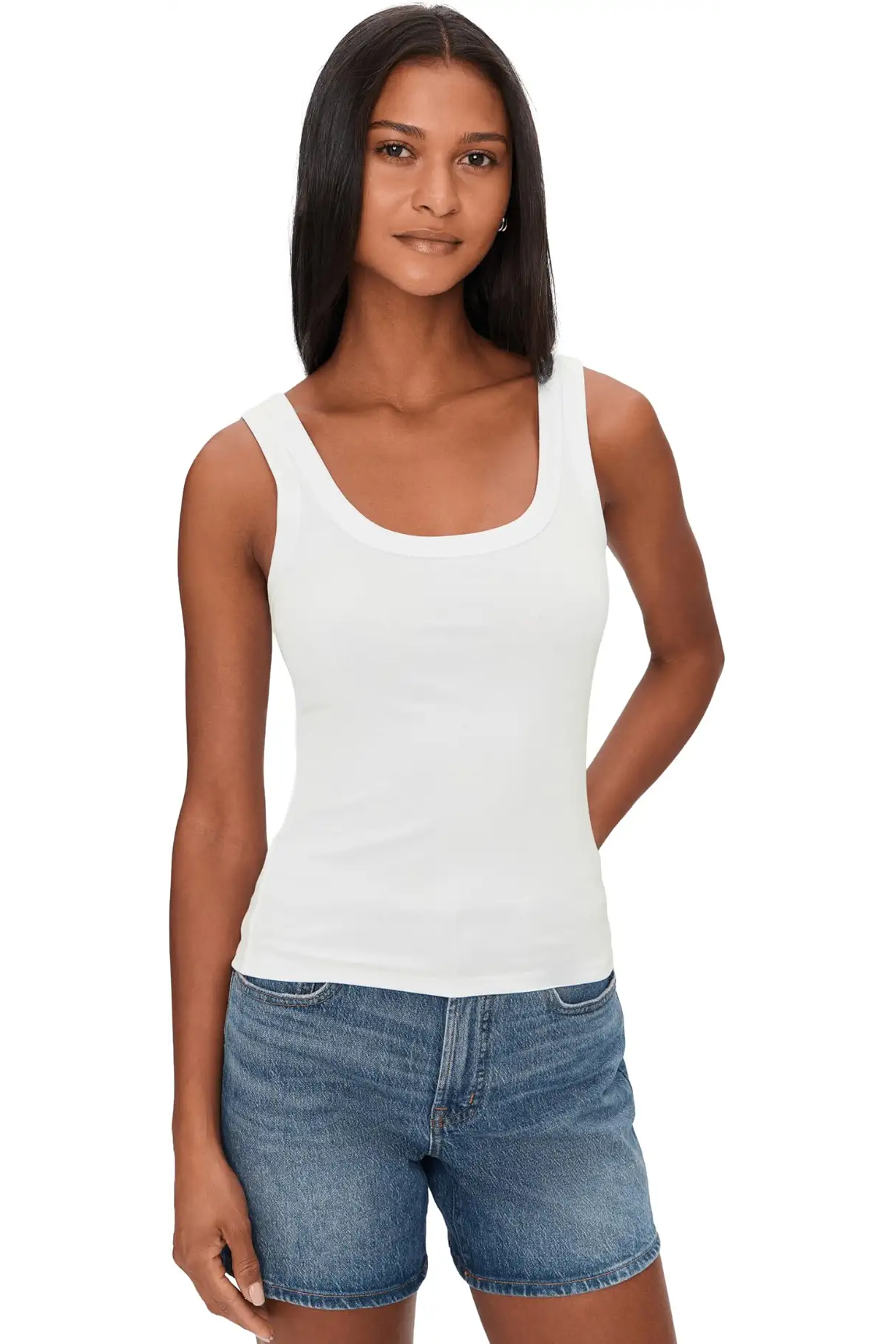 Woman wearing a white ribbed tank top with scoop neckline