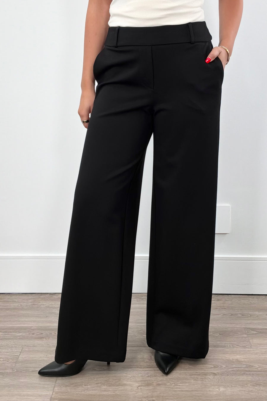 Women wearing black wide-leg pants