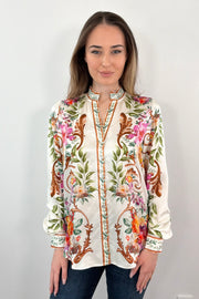 woman wearing an ivory regency printed button down shirt untucked