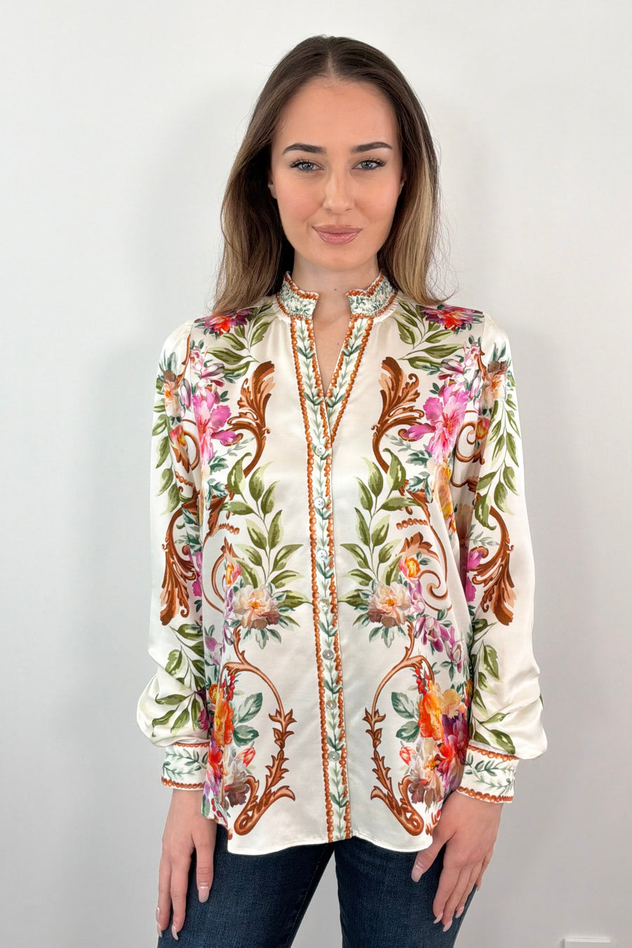 woman wearing an ivory regency printed button down shirt untucked