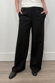Front view of woman wearing a black wide leg ponte pant