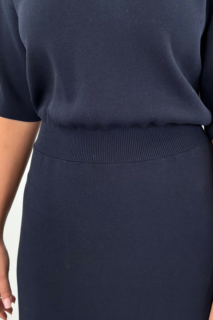 Woman wearing a black knit dress