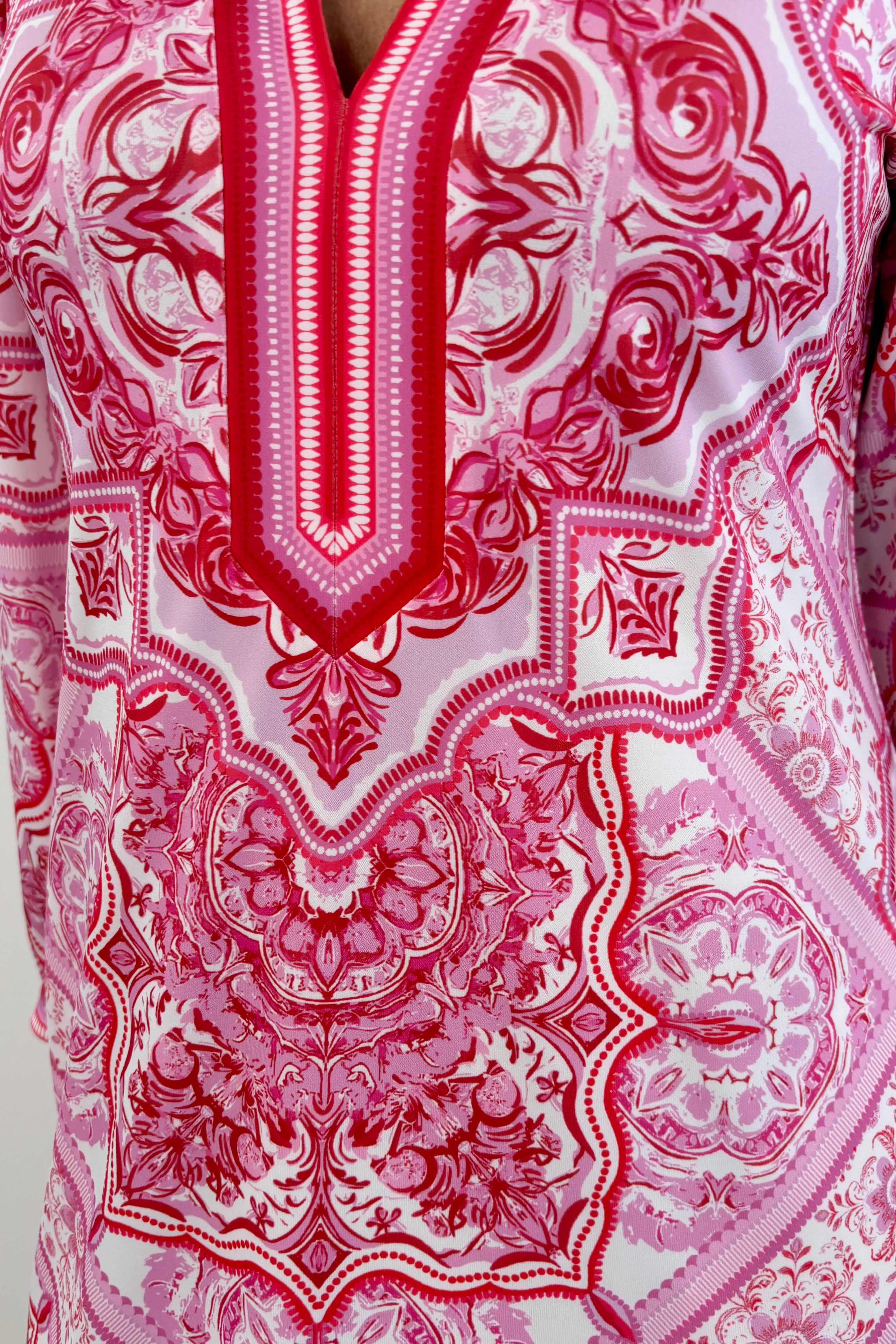 Close up of Woman wearing a light red patterned dress