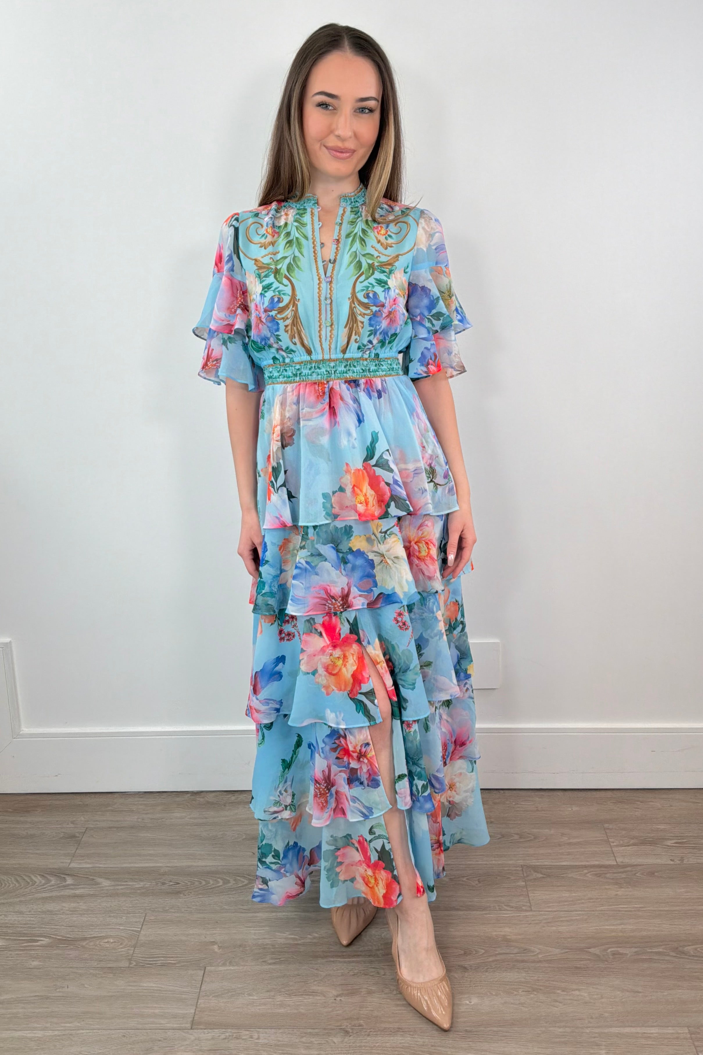woman wearing a teal floral ruffle maxi dress 