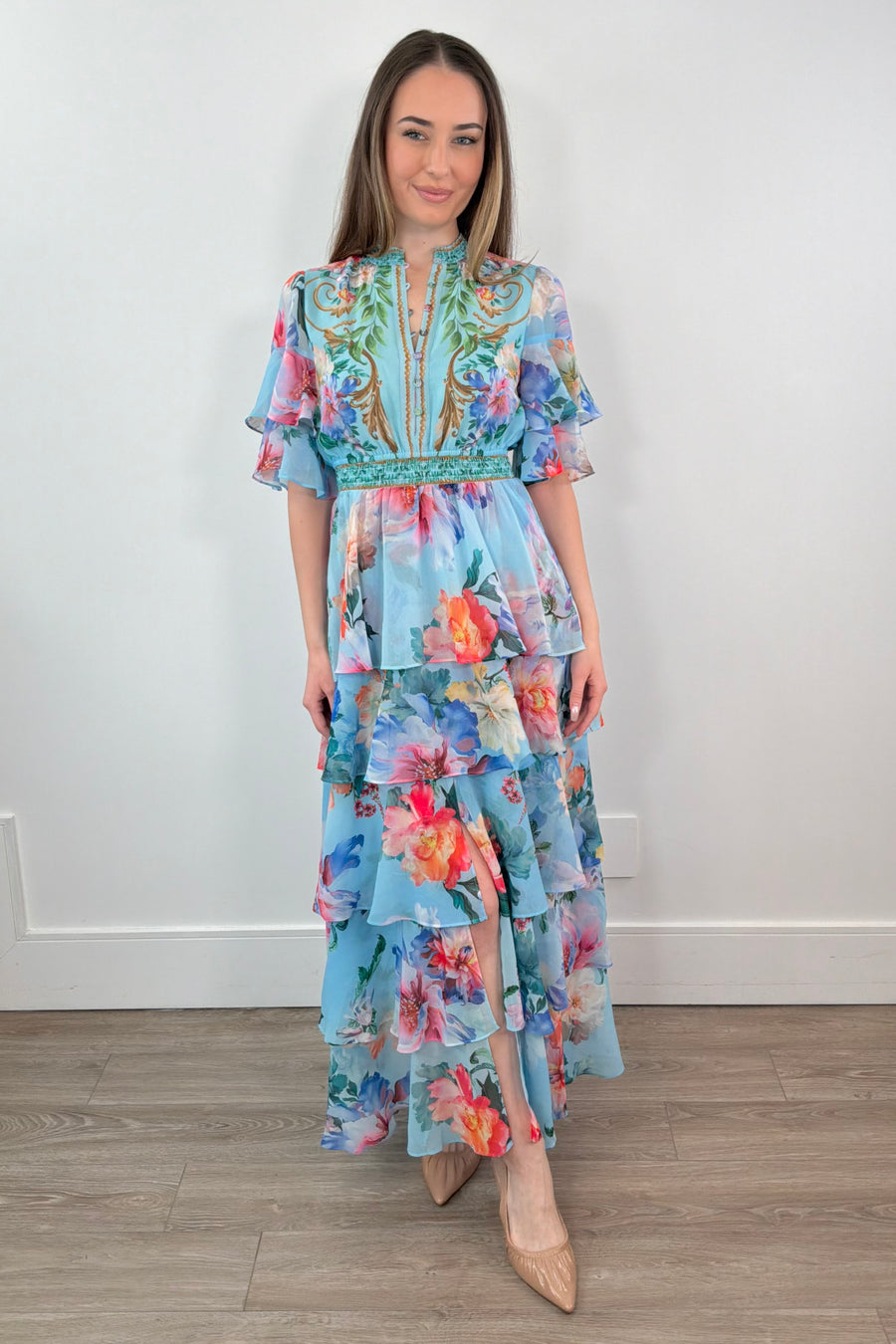 woman wearing a teal floral ruffle maxi dress 