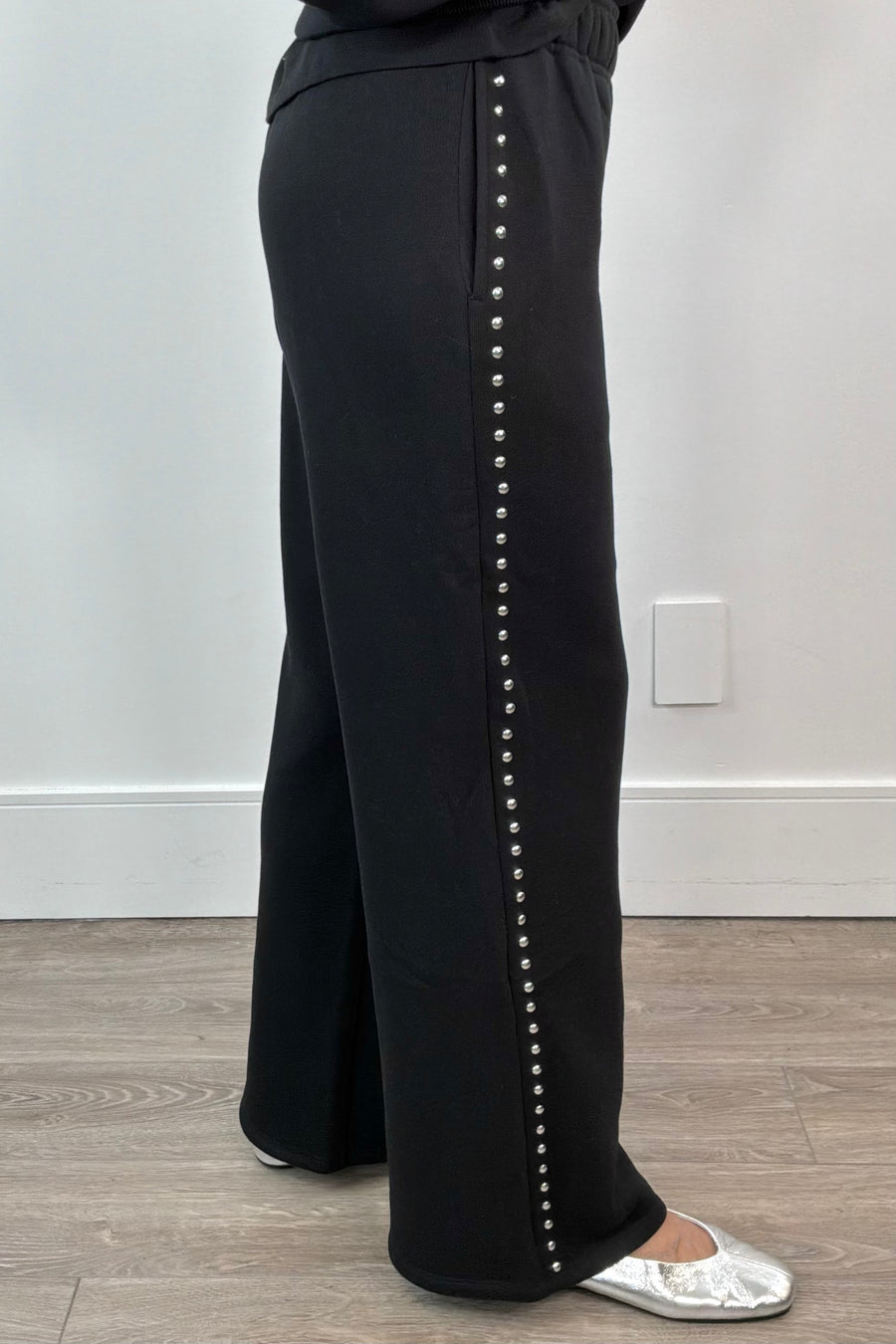black pants with studded side panels