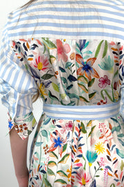 close- up of a white and blue striped dress with a silk floral patterns