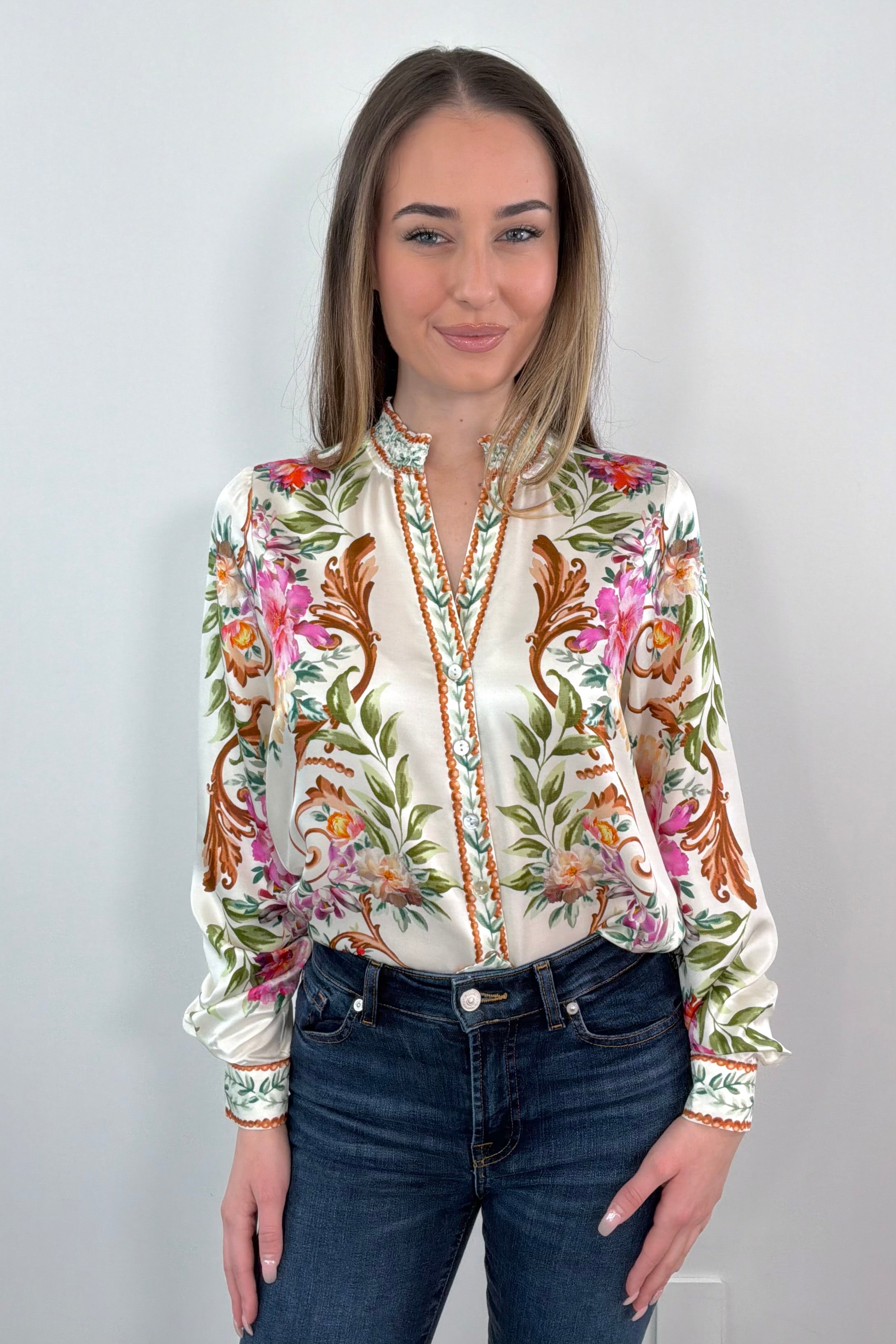 woman wearing an ivory regency printed button down shirt tucked in