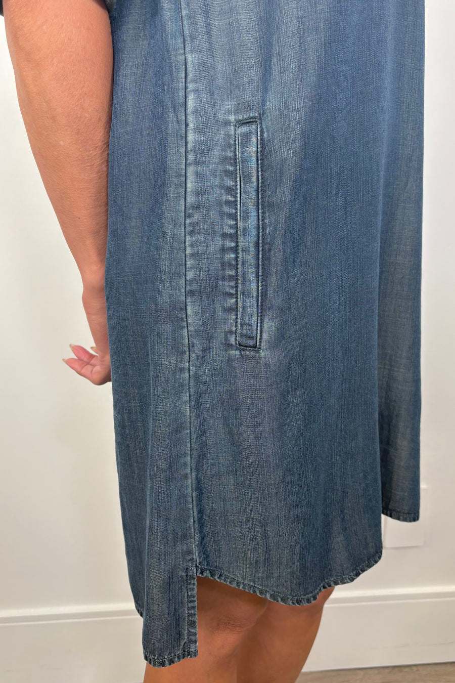 Close-up of the pocket of a blue tencel yoke midi dress