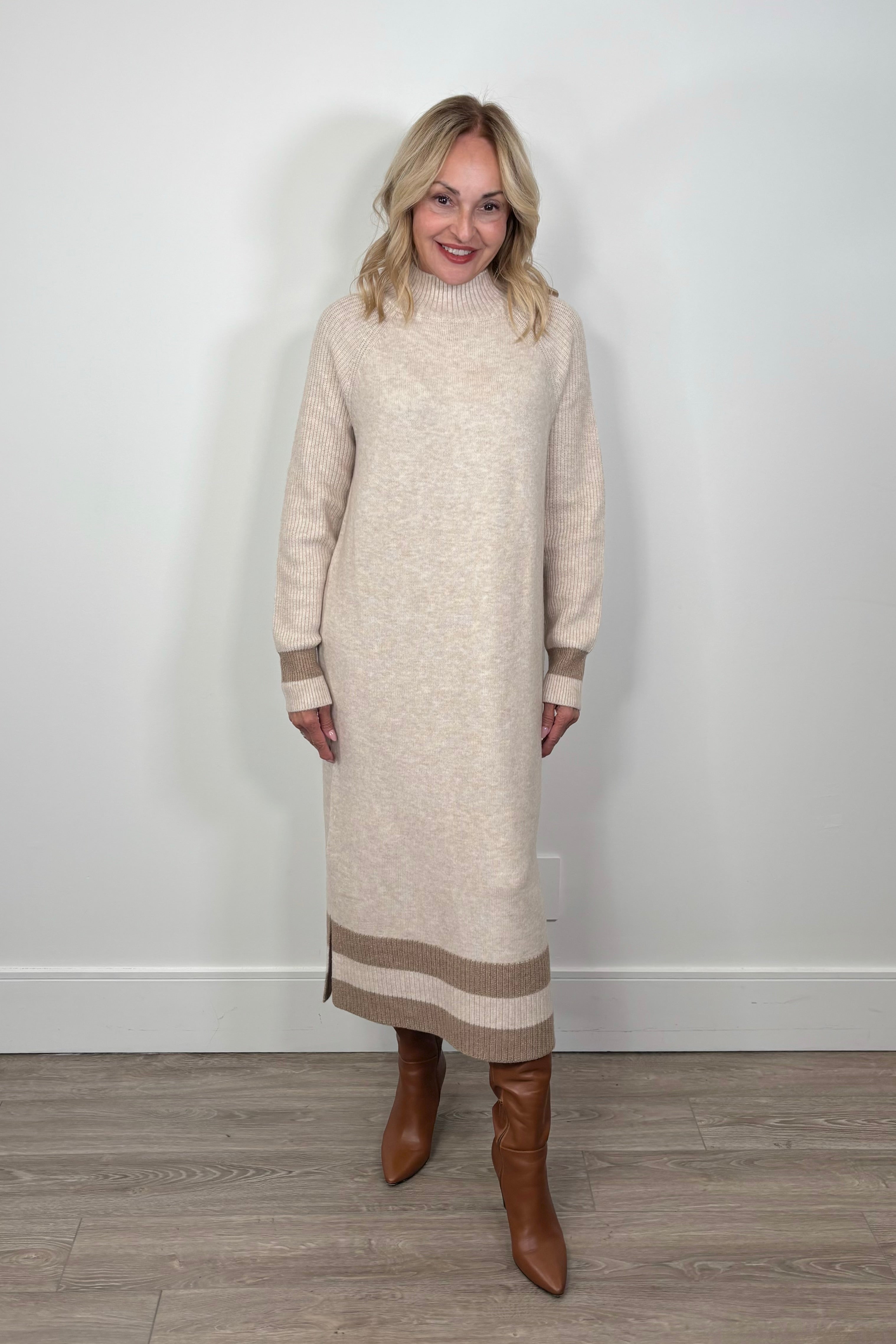 woman wearing a beige maxi long sleeve mock neck sweater dress