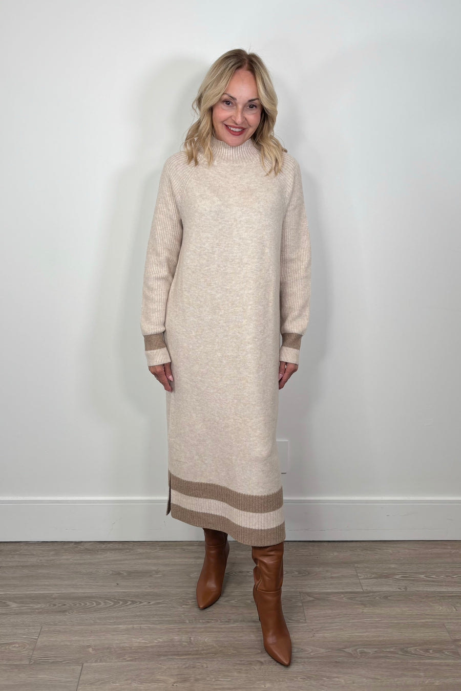 woman wearing a beige maxi long sleeve mock neck sweater dress