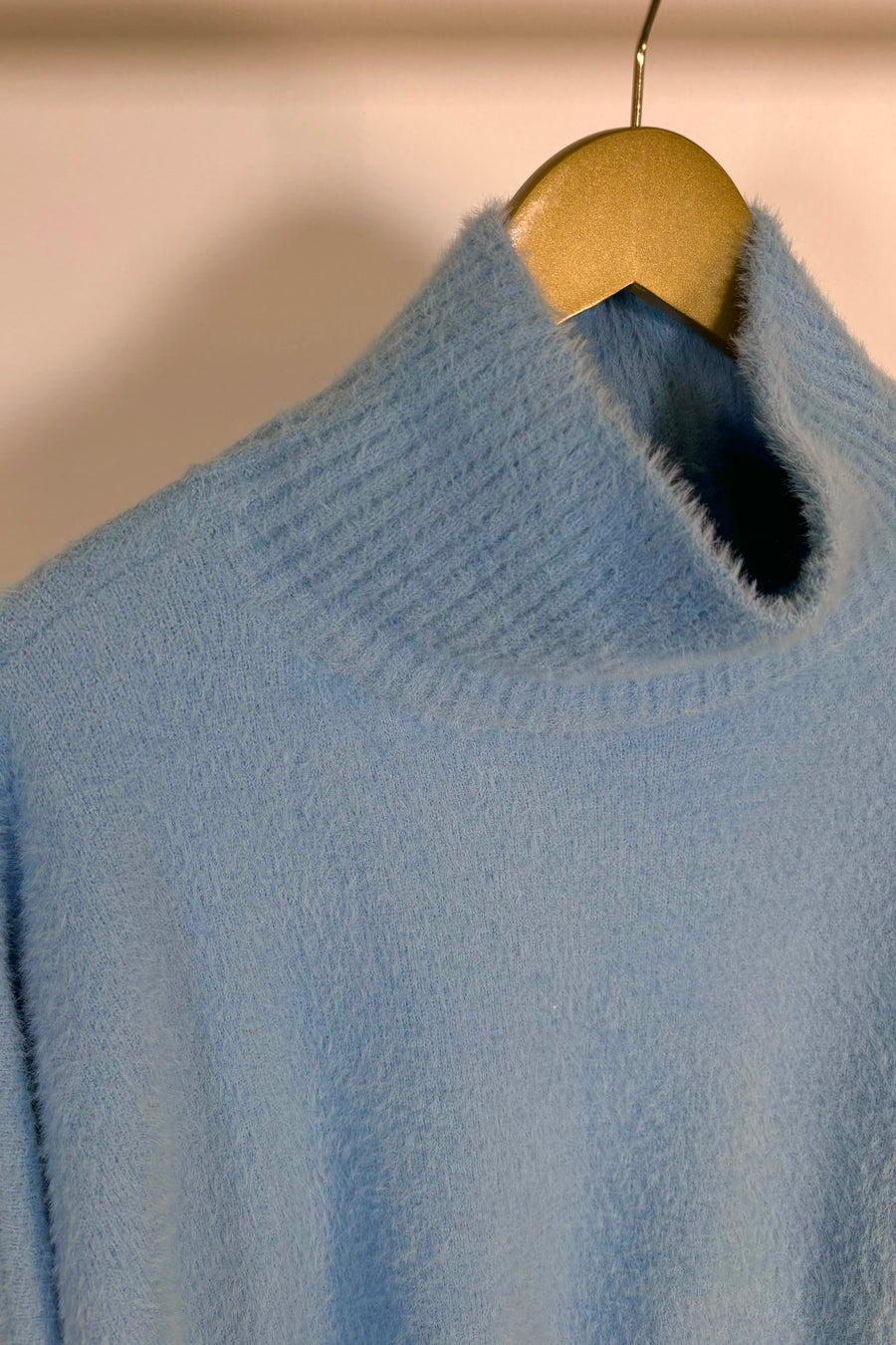 Close-up of baby blue mock neck hairy sweater