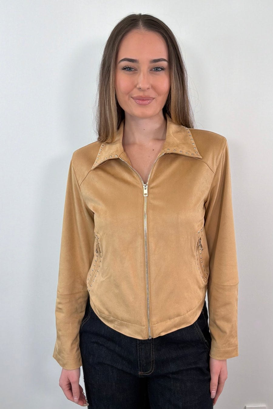 woman wearing a faux suede tan leader jacket with stud details