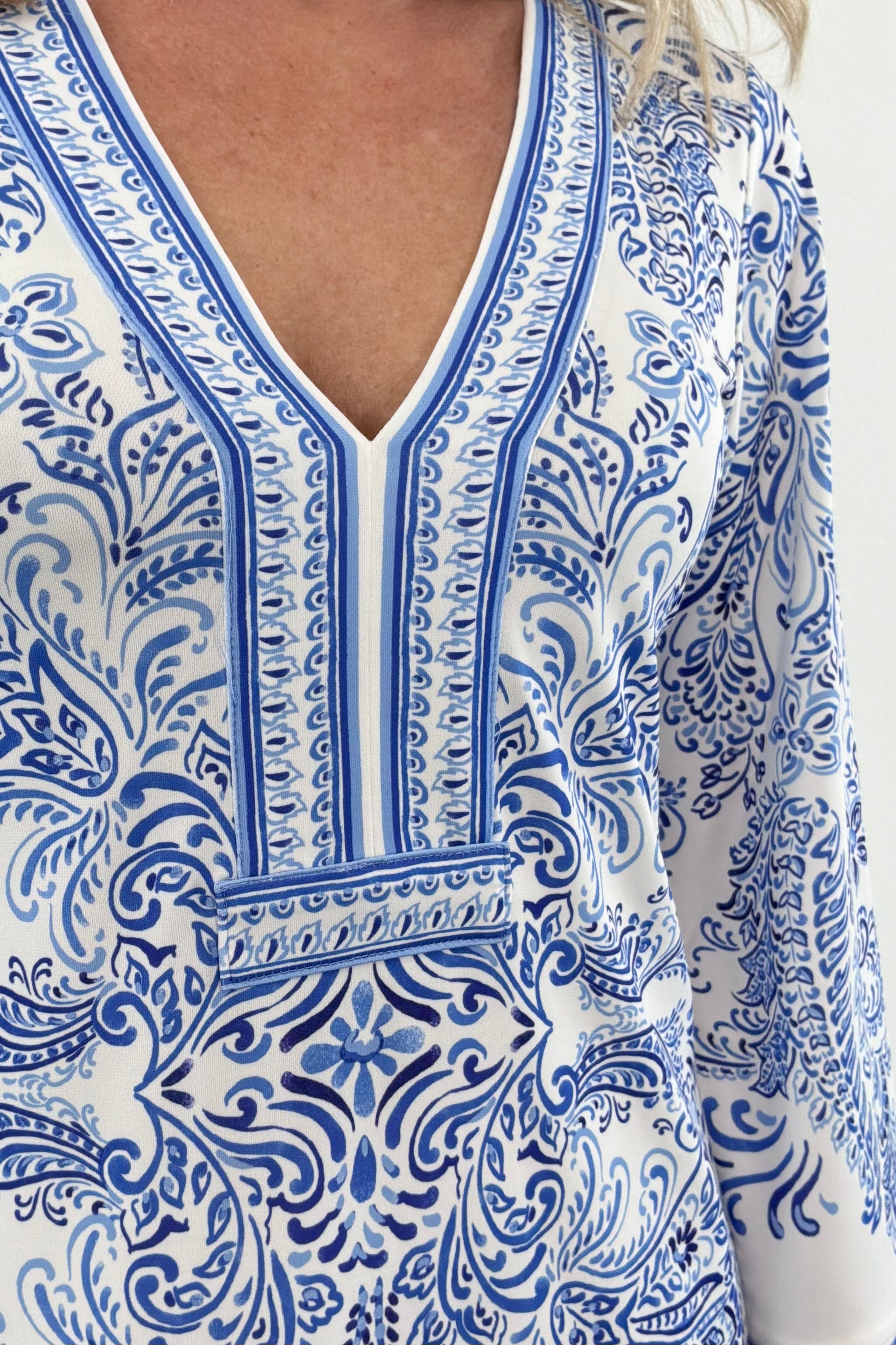 Close up of Woman wearing white dress with blue pattern allover