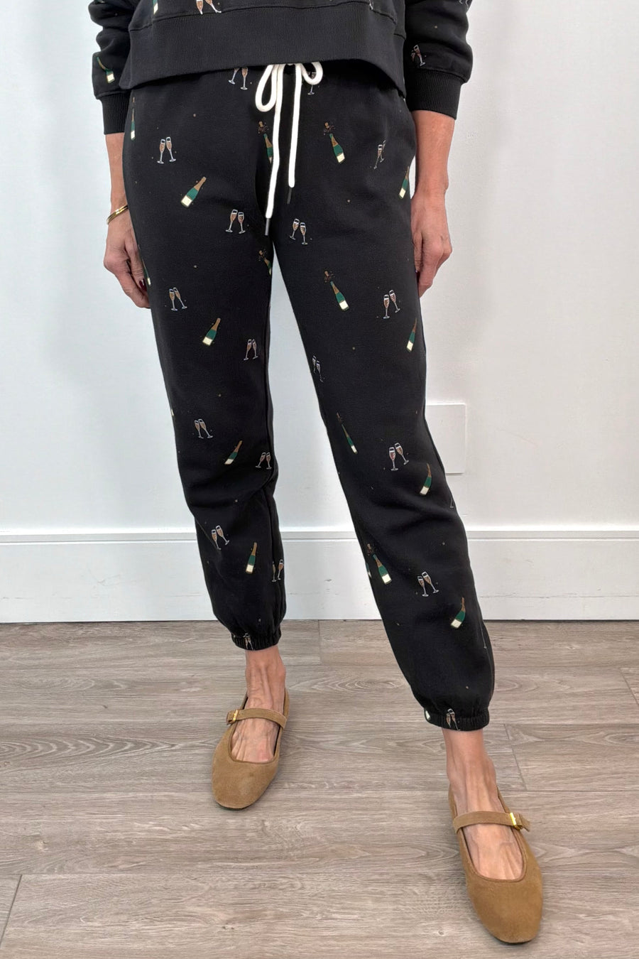 woman wearing straight leg, fitted champagne  print sweatpants