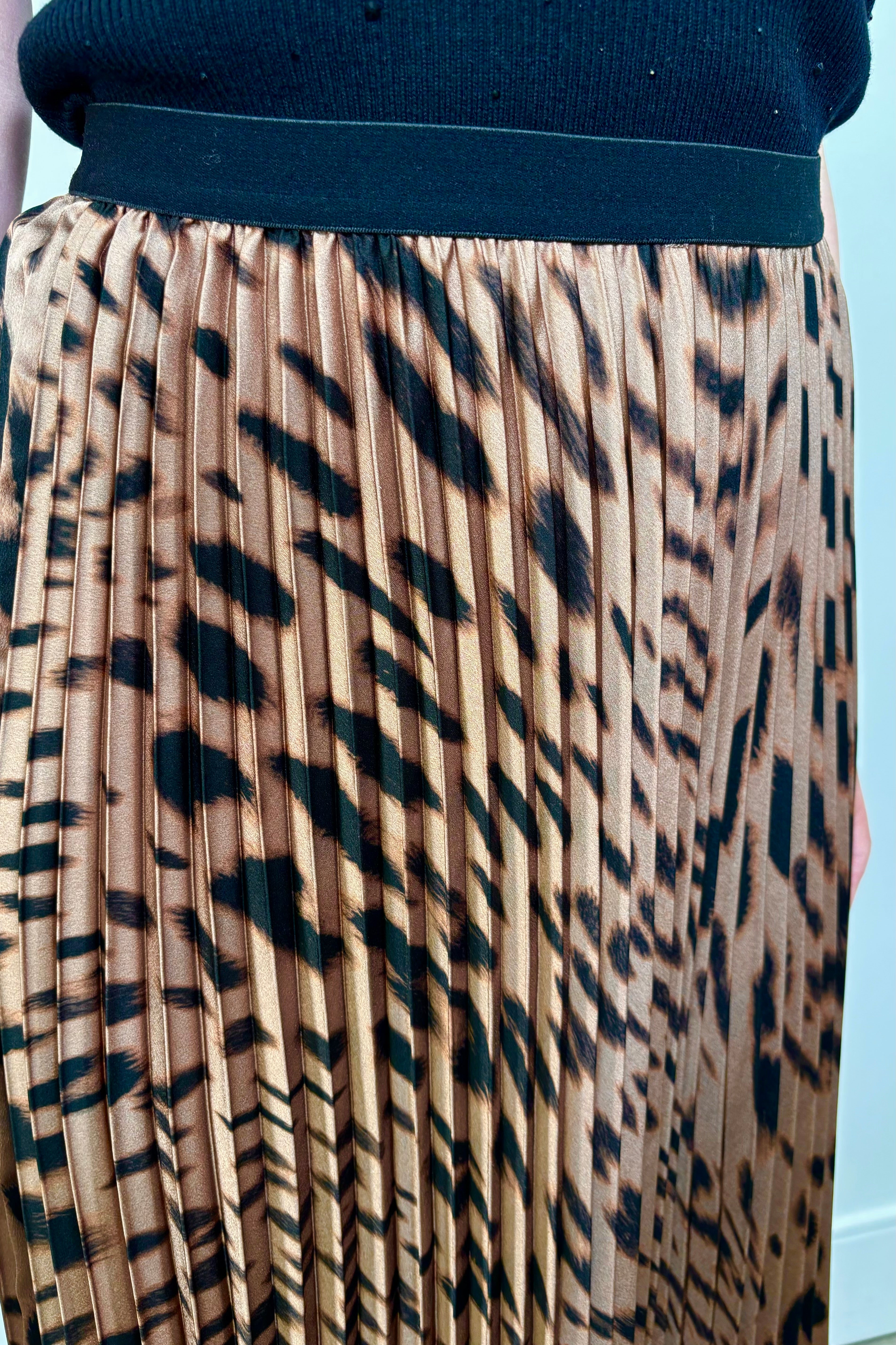 Close up view of a woman wearing a leopard printed midi skirt 