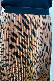 Close up view of a woman wearing a leopard printed midi skirt 